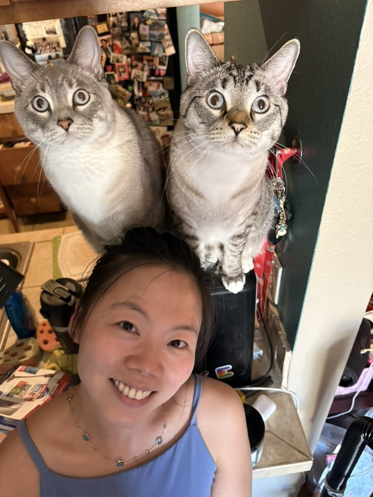 Mama smiling with Tiger and Simba perched just above her