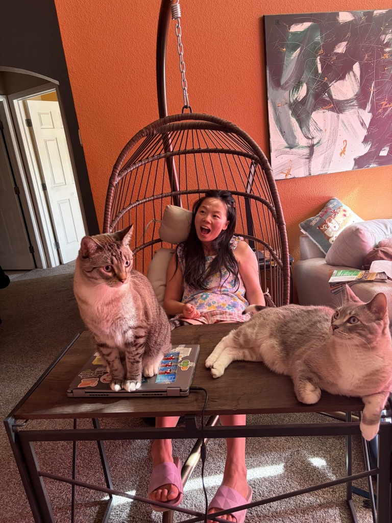 Simba and Tiger sitting on a table with Mama behind them
