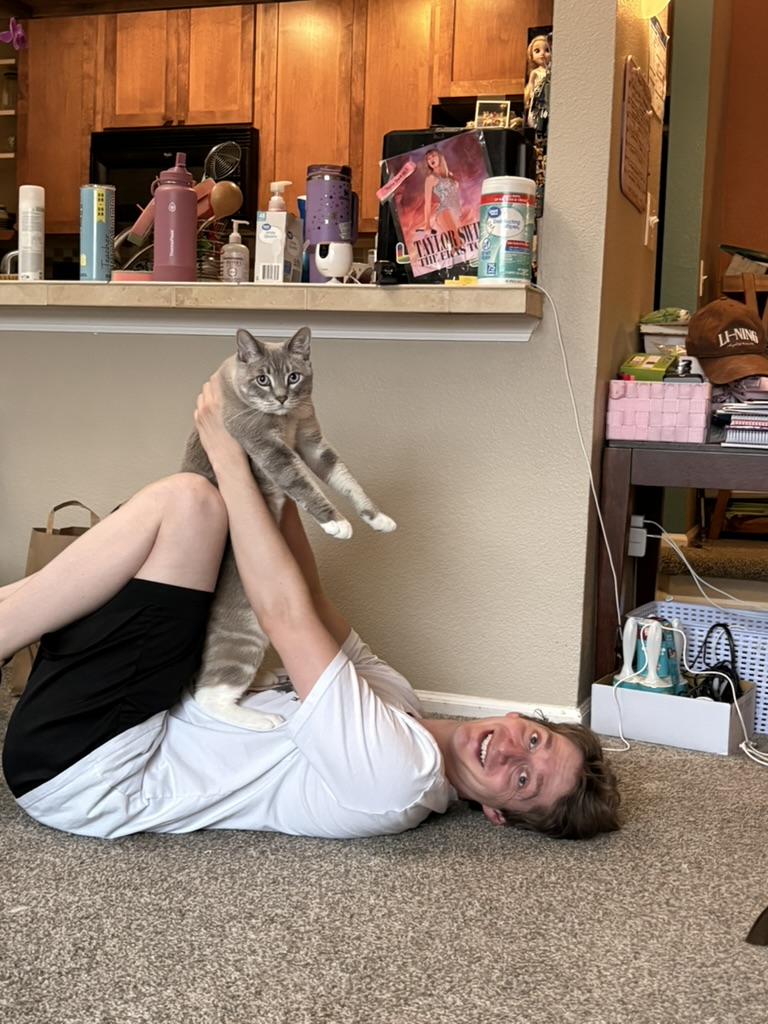 Connor holding Tiger while lying on the carpet