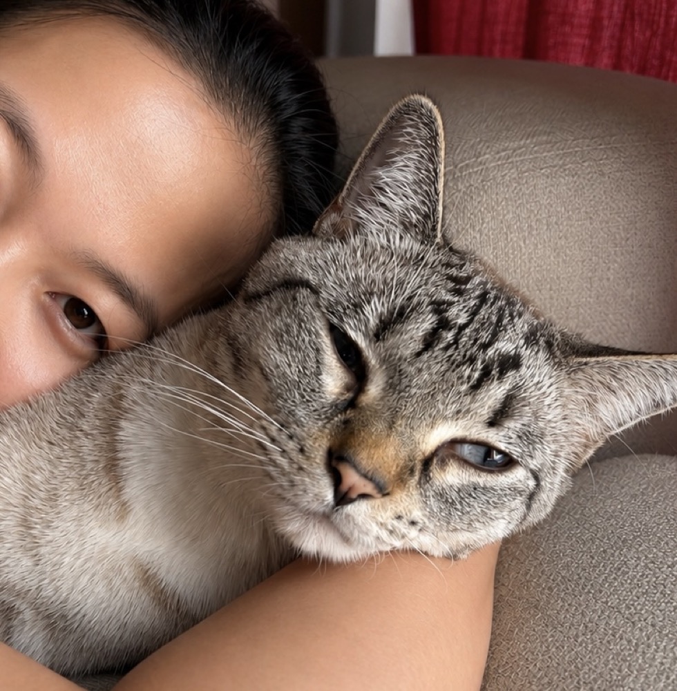Lucy cuddling a tabby cat